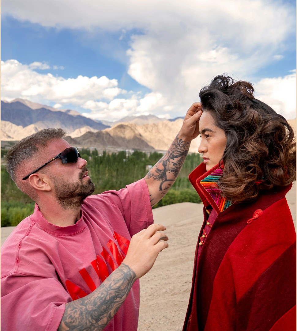 Florian Hurel styling model's hair during professional outdoor fashion shoot